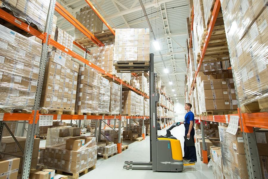 Palletized sacks of raw material stacked in an industrial warehouse